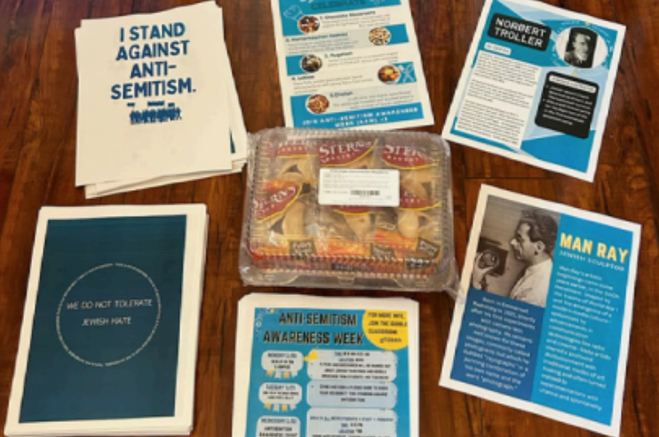 Antisemitism Awareness Week posters and a box of hamantaschen cookies.