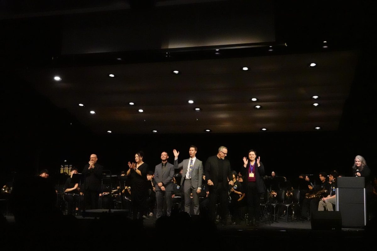 The high school and middle school band directors take the stage for an applause.